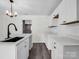 Close-up of the bright, white kitchen with an island, black faucet, and tiled backsplash at 111 Wolfe Rd, Shelby, NC 28152