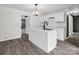 Bright kitchen with white cabinetry, island with a black faucet, and modern chandelier lighting at 111 Wolfe Rd, Shelby, NC 28152