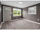 Cozy living room featuring grey walls, a gray door and trim, and waterproof flooring at 111 Wolfe Rd, Shelby, NC 28152