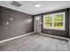 Inviting living room featuring modern gray walls, white trim and waterproof gray flooring at 111 Wolfe Rd, Shelby, NC 28152