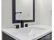Bathroom vanity featuring modern black hardware, a white countertop, and a framed mirror at 113 Woodside Ave, Gastonia, NC 28054
