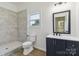 Bathroom featuring walk-in shower, blue vanity with white countertop, and a window at 113 Woodside Ave, Gastonia, NC 28054