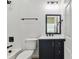 Bathroom with white tile and navy vanity with black fixtures at 113 Woodside Ave, Gastonia, NC 28054
