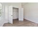 Bright, empty room showcases hardwood floors and closet with open doors, ready to be personalized at 113 Woodside Ave, Gastonia, NC 28054