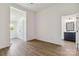 Bright bedroom features wood-look floors, white walls, and ensuite bathroom at 113 Woodside Ave, Gastonia, NC 28054
