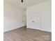 Neutral bedroom offers wood-look floors, white walls, and a double door closet at 113 Woodside Ave, Gastonia, NC 28054