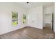Bright bedroom features wood-look floors, white walls, windows, and a double door closet at 113 Woodside Ave, Gastonia, NC 28054