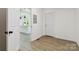 Entryway leading to a bright open kitchen featuring a modern design and an open floor plan at 113 Woodside Ave, Gastonia, NC 28054