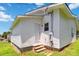 Exterior view shows the side and back of the house with the entry door and well-maintained lawn at 113 Woodside Ave, Gastonia, NC 28054