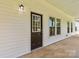 Inviting front entrance featuring a dark-colored door with glass window and decorative siding at 113 Woodside Ave, Gastonia, NC 28054