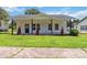 Classic white home with a covered porch and lush green lawn, perfect for relaxation and curb appeal at 113 Woodside Ave, Gastonia, NC 28054