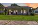 Charming white bungalow featuring a covered porch, dark-framed windows, and a lush green lawn at 113 Woodside Ave, Gastonia, NC 28054