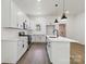 Bright kitchen features stainless steel appliances, white cabinets, quartz countertops, and a center island at 113 Woodside Ave, Gastonia, NC 28054