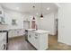 Beautiful island kitchen with stainless appliances, white cabinets and a modern aesthetic at 113 Woodside Ave, Gastonia, NC 28054