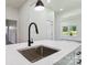 Kitchen island with a stainless steel sink and black faucet, bright interior and wood-style flooring at 113 Woodside Ave, Gastonia, NC 28054