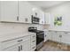 Bright kitchen features stainless steel appliances, white cabinets, quartz countertops, and natural lighting at 113 Woodside Ave, Gastonia, NC 28054