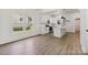 Open concept kitchen with white cabinets, stainless appliances and a large adjacent living area with natural light at 113 Woodside Ave, Gastonia, NC 28054