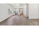 Spacious living room with sleek floors offers abundant natural light and open access to the updated kitchen at 113 Woodside Ave, Gastonia, NC 28054