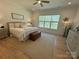 Spacious bedroom featuring hardwood floors, a cozy bed, and large window with natural light at 11404 James Coy Rd, Davidson, NC 28036