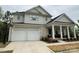 Lovely two-story home boasts a two-car garage and charming front porch with decorative columns at 11404 James Coy Rd, Davidson, NC 28036