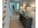 Hallway with an embellished console table and decor accents by a staircase in a well-lit hallway at 11404 James Coy Rd, Davidson, NC 28036