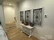 Hallway features a decorative console table with decorative wall art and hardwood flooring at 11404 James Coy Rd, Davidson, NC 28036