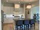 Bright kitchen featuring stainless steel appliances, a central island with chairs, and modern pendant lighting at 11404 James Coy Rd, Davidson, NC 28036