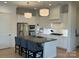 Bright kitchen featuring stainless steel appliances, a central island with chairs, and modern pendant lighting at 11404 James Coy Rd, Davidson, NC 28036