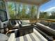Comfortable outdoor seating area featuring a stylish rug and beautiful wooded views at 11404 James Coy Rd, Davidson, NC 28036