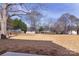 Large backyard with grass and trees at 118 Durham Rd, Stanley, NC 28164