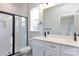 Well-lit bathroom with double sinks, modern fixtures, and a glass-enclosed shower at 118 Durham Rd, Stanley, NC 28164