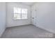 Bedroom with large window, neutral carpet and closet at 118 Durham Rd, Stanley, NC 28164