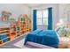 Charming ' bedroom with playful blue decor, shelving and a comfortable bed at 118 Durham Rd, Stanley, NC 28164