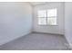 Cozy bedroom with plush carpeting and a bright window overlooking the outdoors at 118 Durham Rd, Stanley, NC 28164