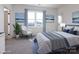 Stylishly furnished bedroom with light blue accents, artwork, and a large window at 118 Durham Rd, Stanley, NC 28164