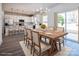 Bright dining room features a wooden table and modern chandelier, adjacent to the kitchen at 118 Durham Rd, Stanley, NC 28164
