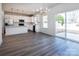 Bright open concept living space connects modern kitchen to dining area with outdoor access at 118 Durham Rd, Stanley, NC 28164