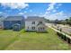 Expansive backyard features a well-maintained lawn, a covered patio, and views of neighboring homes and streets at 12009 Grinstead Ln # 303, Charlotte, NC 28278