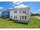Spacious backyard with a covered patio, lush green lawn, and serene views of the surrounding landscape at 12009 Grinstead Ln # 303, Charlotte, NC 28278