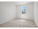 Bright bedroom featuring plush carpeting and a window with a view of the neighborhood at 12009 Grinstead Ln # 303, Charlotte, NC 28278