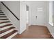 Bright foyer featuring hardwood floors, a staircase, and natural light, offering a welcoming entrance at 12009 Grinstead Ln # 303, Charlotte, NC 28278