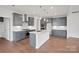 Modern kitchen featuring sleek cabinetry, stainless steel appliances, an island, and hardwood floors at 12009 Grinstead Ln # 303, Charlotte, NC 28278
