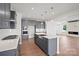Modern kitchen featuring gray cabinets, stainless steel appliances, quartz countertops and hardwood floors at 12009 Grinstead Ln # 303, Charlotte, NC 28278
