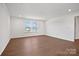 Spacious living room with hardwood floors and natural light streaming in through large windows at 12009 Grinstead Ln # 303, Charlotte, NC 28278