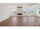 Bright living room featuring a modern fireplace, hardwood floors, recessed lights and many windows at 12009 Grinstead Ln # 303, Charlotte, NC 28278