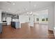 Open-concept living space with modern kitchen, hardwood floors, neutral walls, and lots of natural light at 12009 Grinstead Ln # 303, Charlotte, NC 28278
