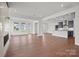 Open-concept living space with hardwood floors, fireplace, lots of natural light, and seamless flow to the kitchen at 12009 Grinstead Ln # 303, Charlotte, NC 28278