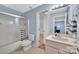 Well-lit bathroom featuring a shower, toilet, and vanity with ample counter space and a large mirror at 122 Long Cove Ln, Mooresville, NC 28117