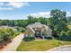 Charming home with manicured lawn, circular driveway, and mature trees at 122 Long Cove Ln, Mooresville, NC 28117