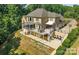 Beautiful home showcasing a large deck, screened in porch, and spiral staircase to a lower patio at 122 Long Cove Ln, Mooresville, NC 28117